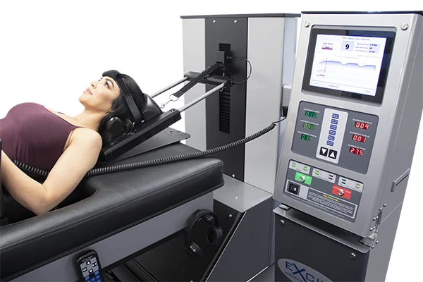 Close-up of a patient positioned on a cervical decompression device with a digital control panel.